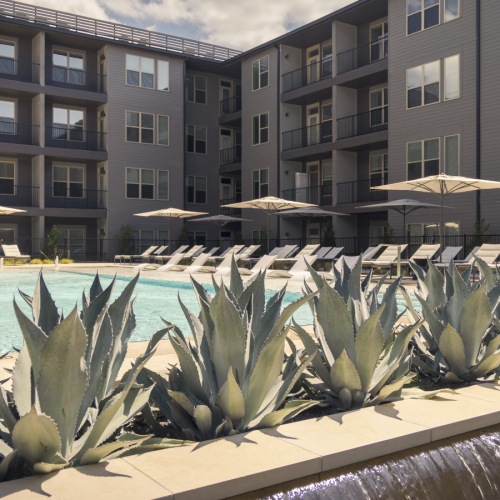 Exterior pool in courtyard with lounge chairs