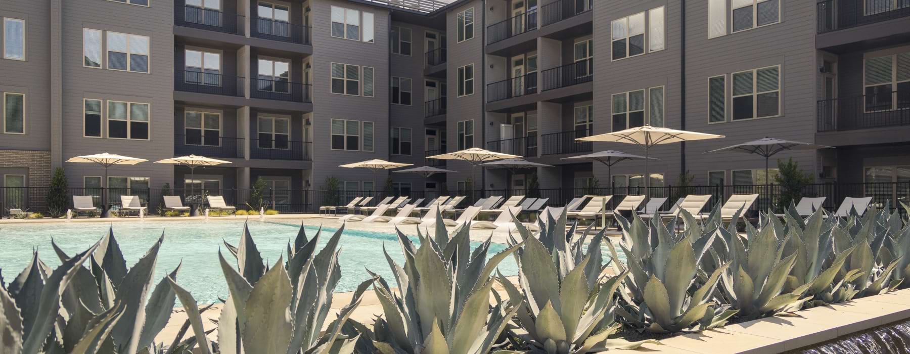 Exterior pool in courtyard with lounge chairs